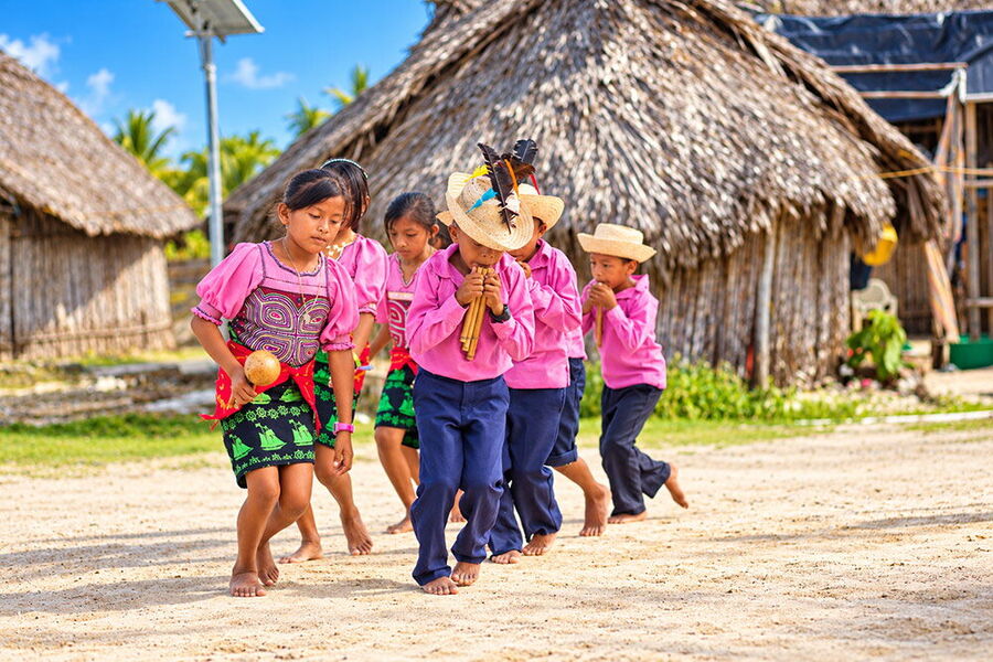 Guna children playing traditional music in their island community