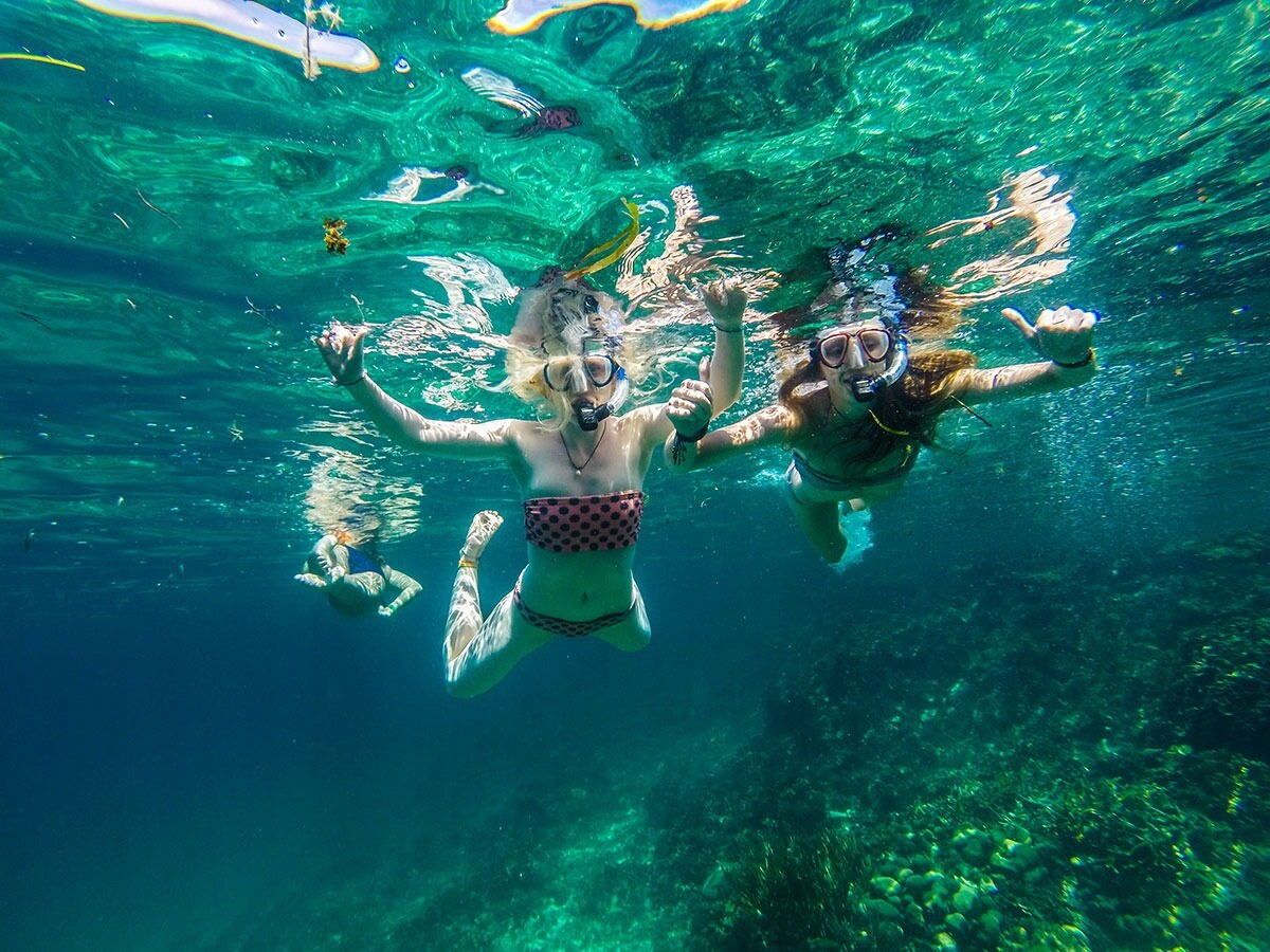Snorkeling over coral reef in crystal clear San Blas water